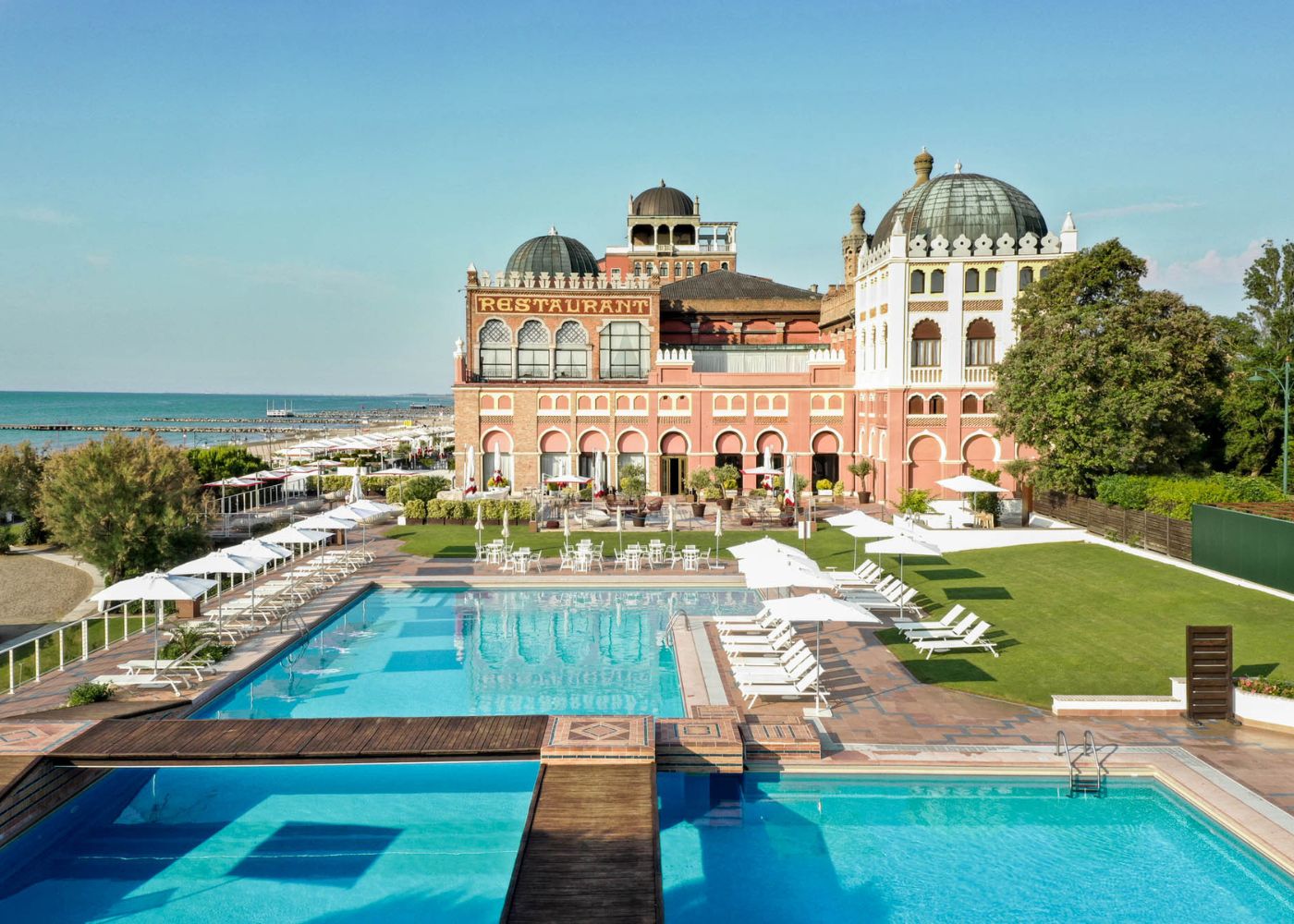 The grand, Moorish-style facade of the Hotel Excelsior on the Venice Lido beachfront.