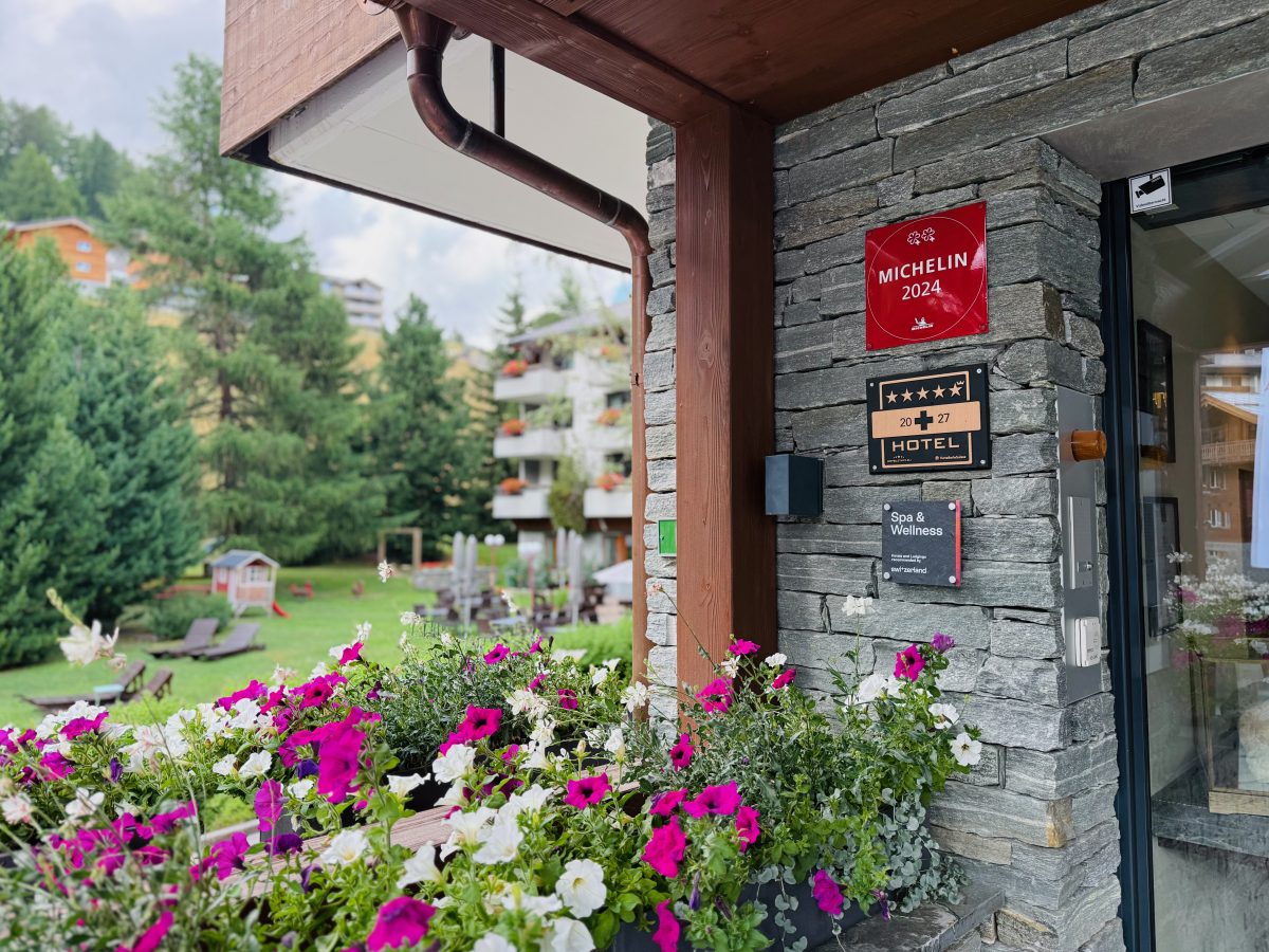 The wooden exterior and balcony of The Capra hotel in Saas-Fee during winter.