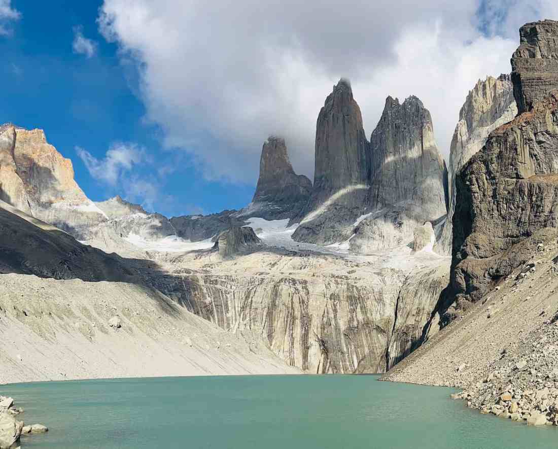 The sharp granite peaks of Torres del Paine under a clear sky.