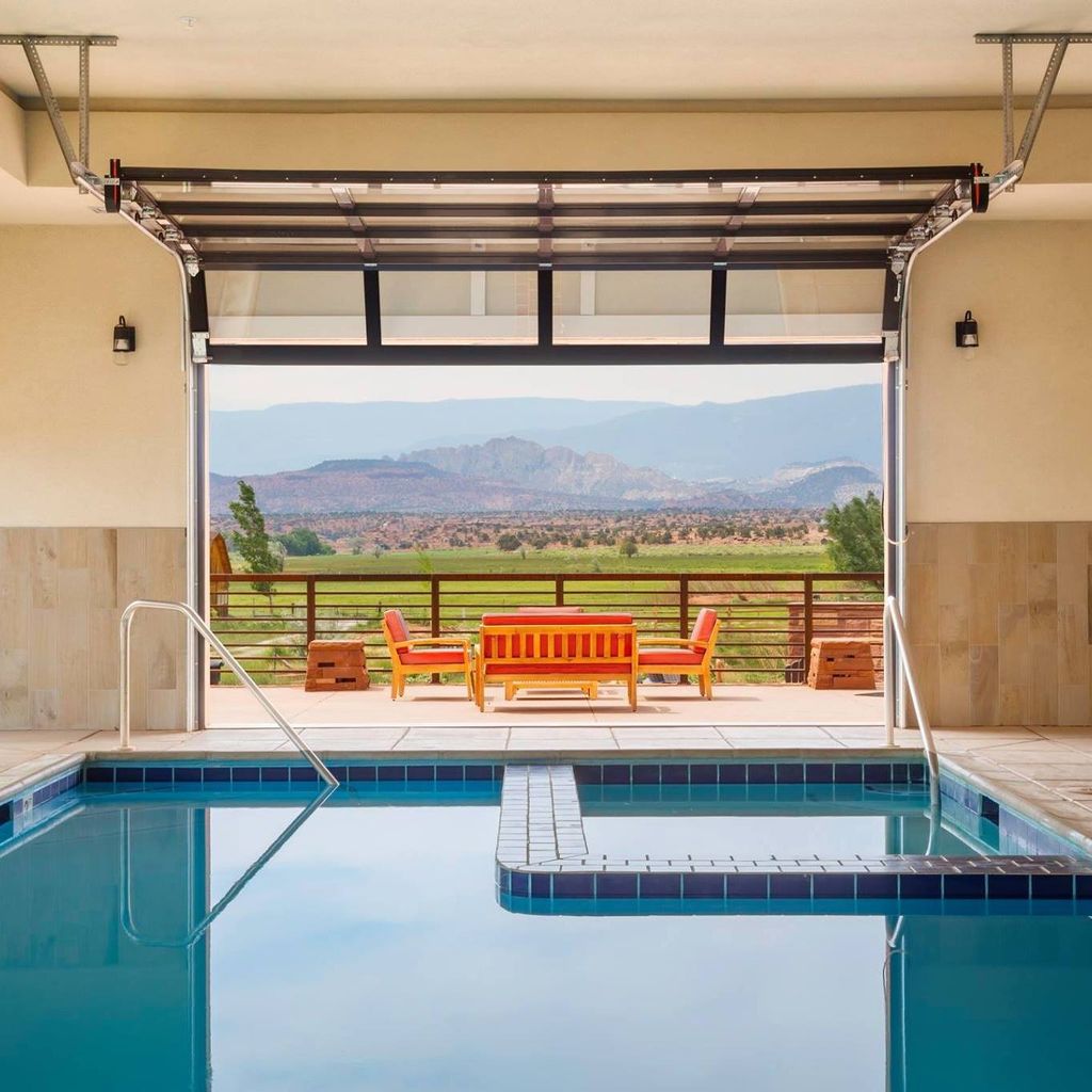 Indoor swimming pool at Red Sands Hotel with large windows looking out toward the mountains.
