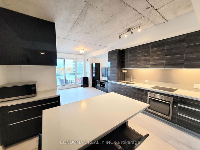 A multi-story loft interior view showing the mezzanine level overlooking the living area.