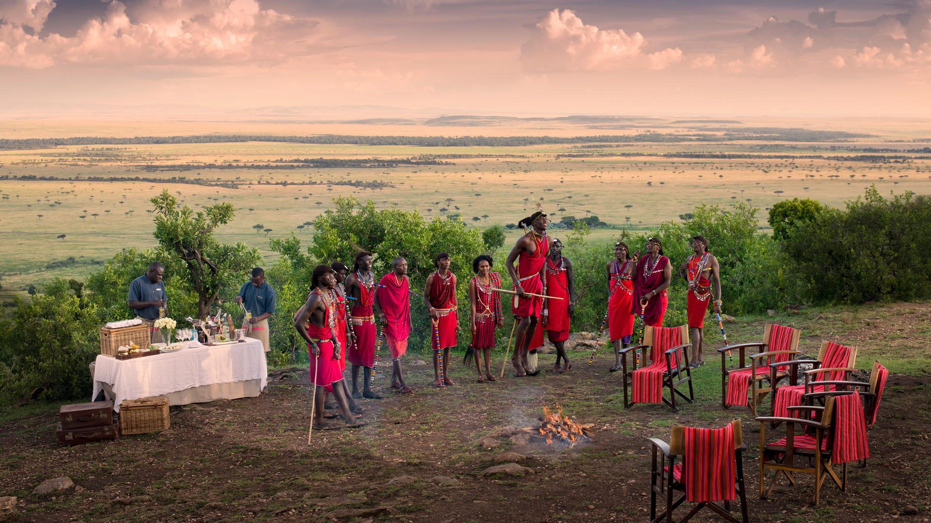 Maasai people dressed in traditional red Shuka cloth in the savannah.