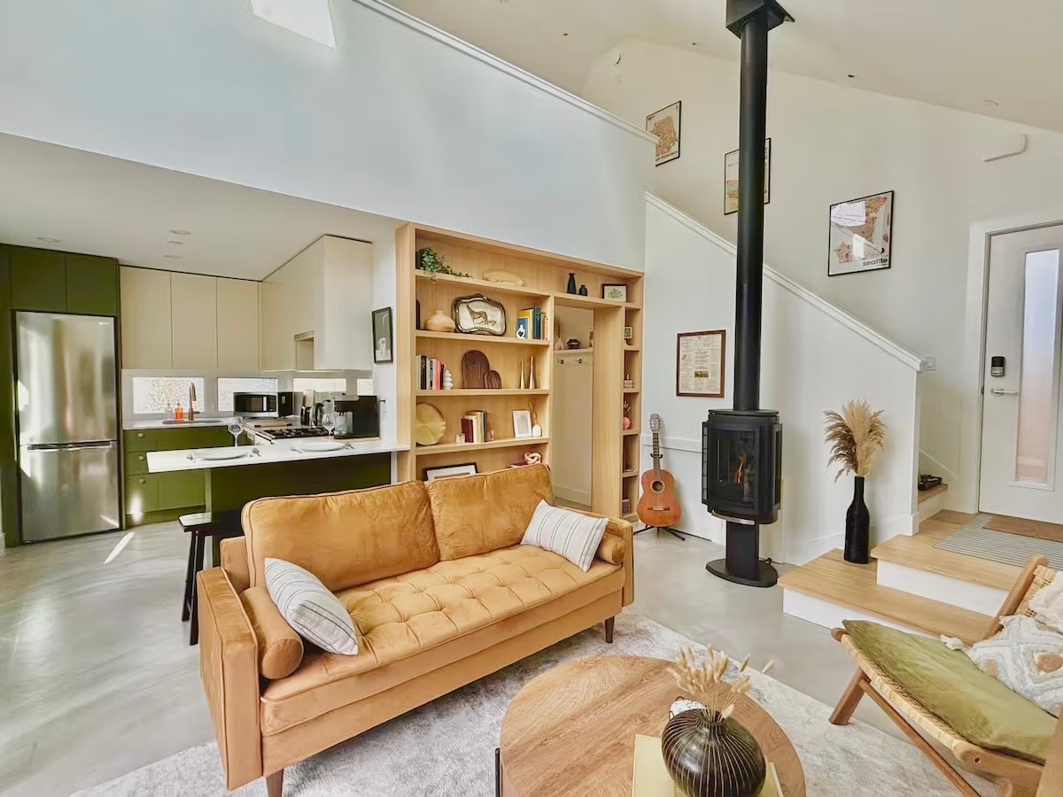 An open-concept living space with a modern kitchen and comfortable gray sofa.