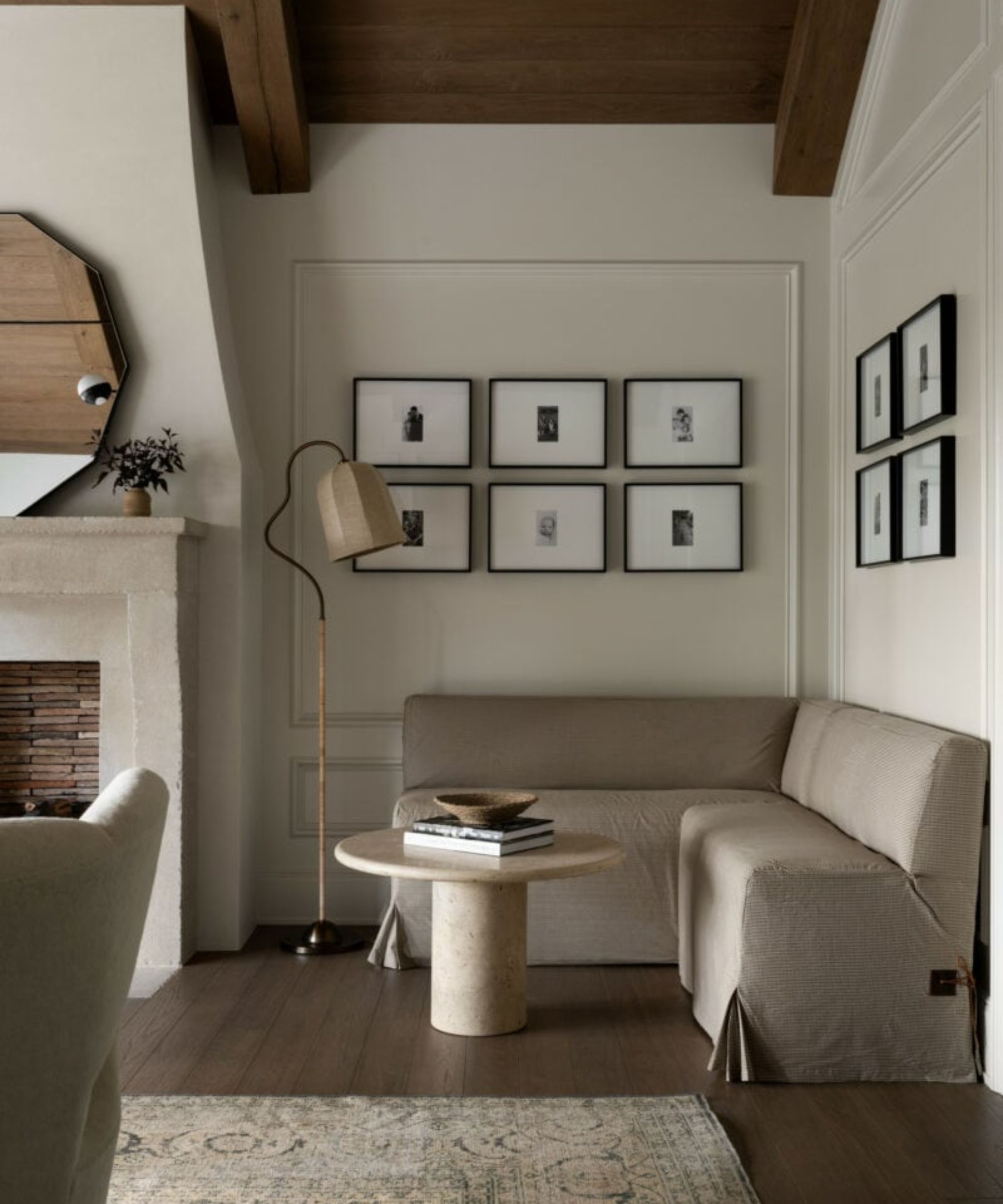 A cozy bedroom reading nook with a fireplace and built-in banquette seating.