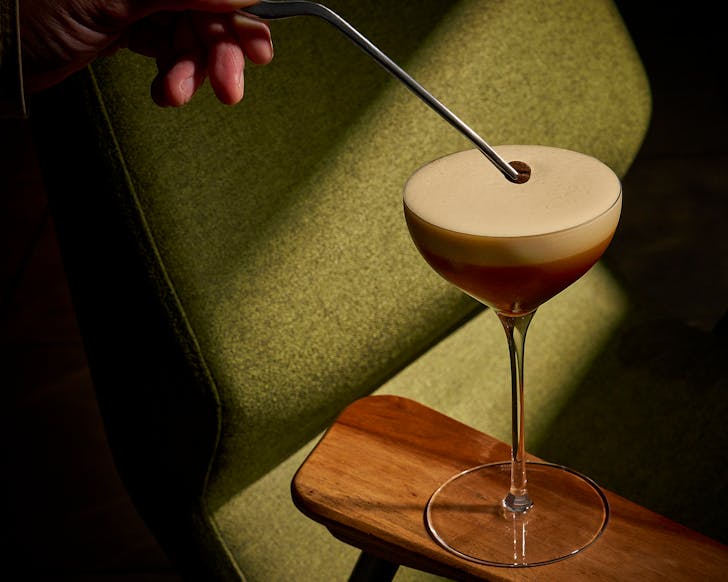 A perfectly poured Espresso Martini in a chilled glass at a luxury bar
