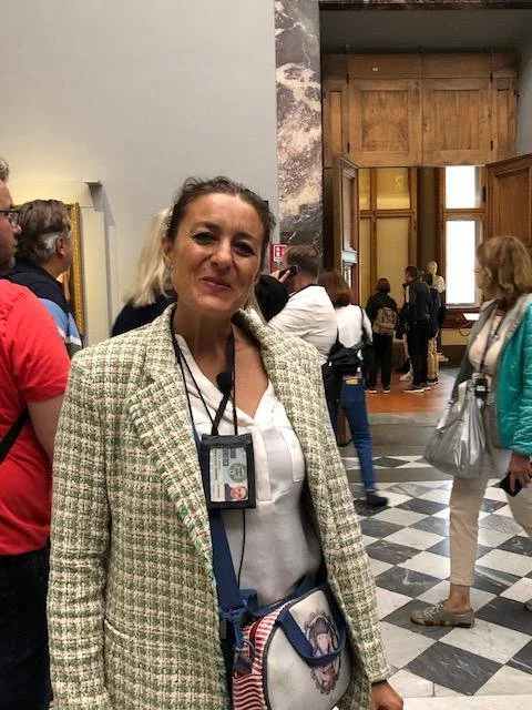 Wide-angle view of terracotta rooftops and historic church domes in Rome from a private terrace.
