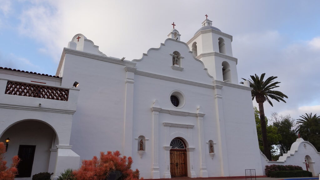 The white facade and classic Spanish mission architecture of Mission San Luis Rey.