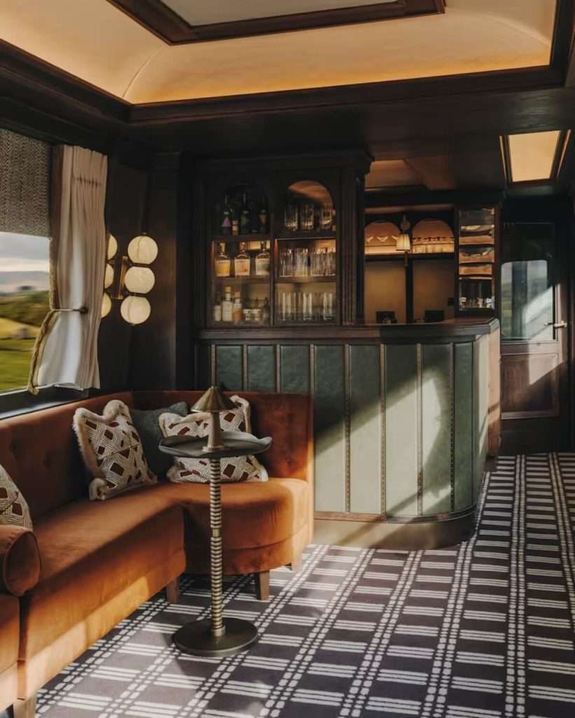 The Britannic Explorer luxury train traveling through the lush green English countryside.
