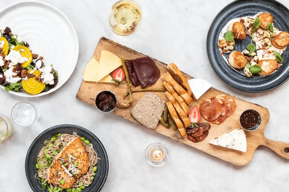 The exterior of The Collins Quarter restaurant with sidewalk seating.