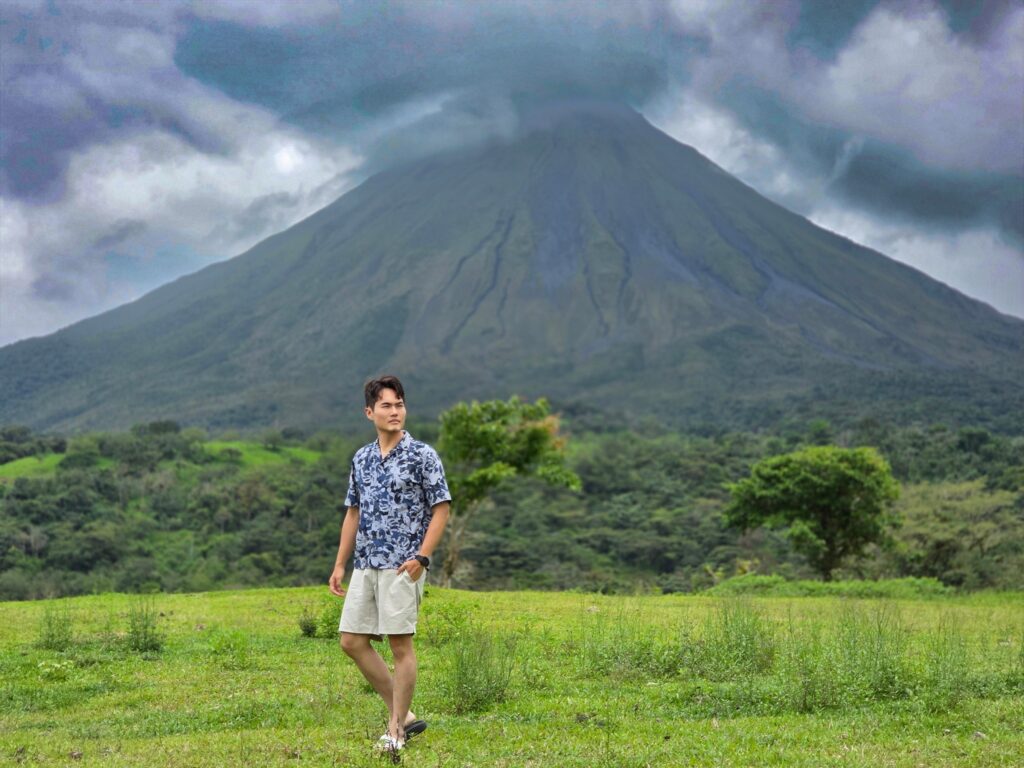 Lush tropical waterfall flowing into a pool surrounded by dense green jungle in Costa Rica.