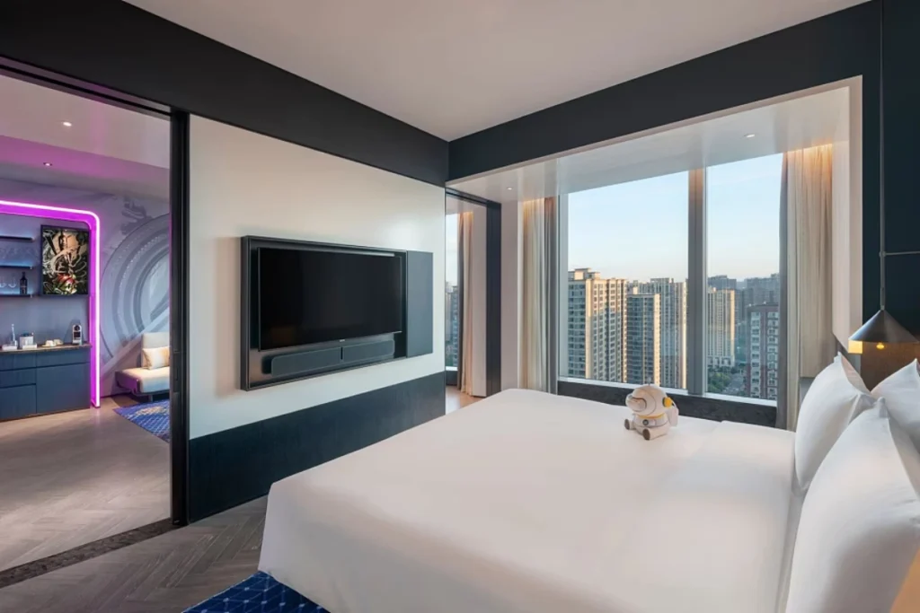 Modern hotel room with integrated smart technology and ambient mood lighting.
