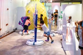 Children playing in an art and tech exhibit featuring Nickelodeon characters.