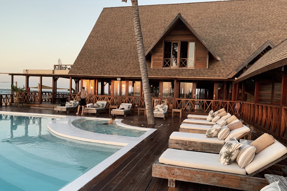 The retro-styled swimming pool area at Sea Sea Hotel surrounded by palm trees and mid-century design elements.
