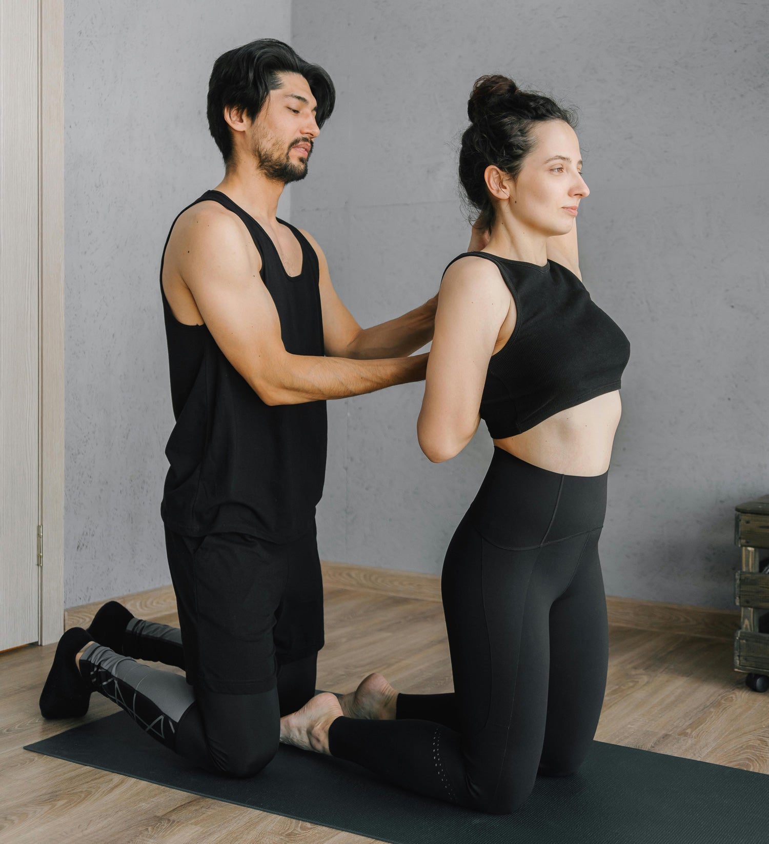 A therapist performing a traditional Thai yoga massage stretch on a client.