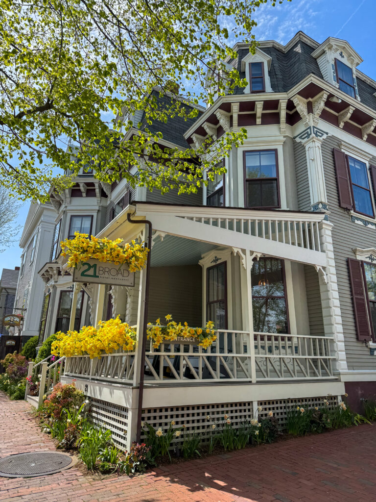The small white Brant Point Lighthouse on the sandy shore of Nantucket.