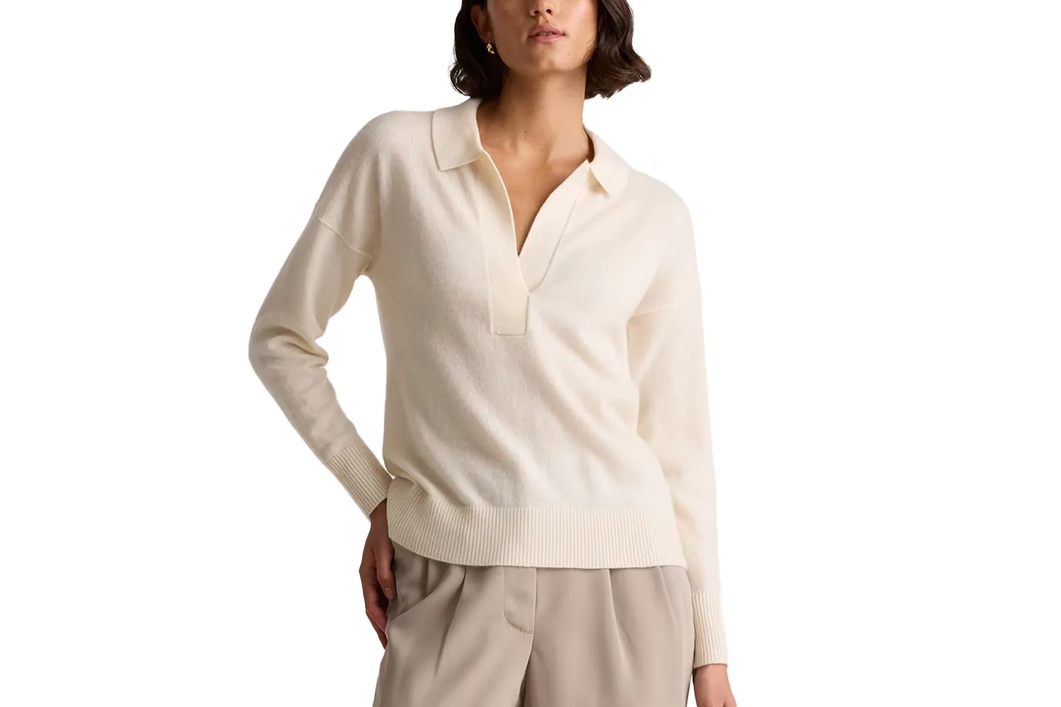 A woman wearing a grey Mongolian cashmere polo sweater with a relaxed fit.