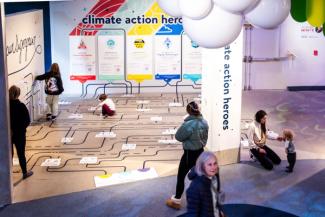 A child using a physical quiz station to discover their climate action superpower.