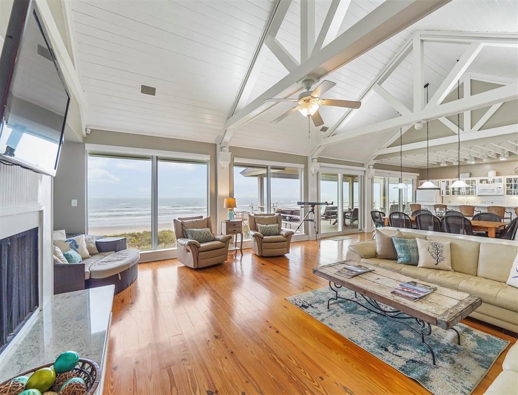 Bright, modern open-concept living room with large windows overlooking the ocean.