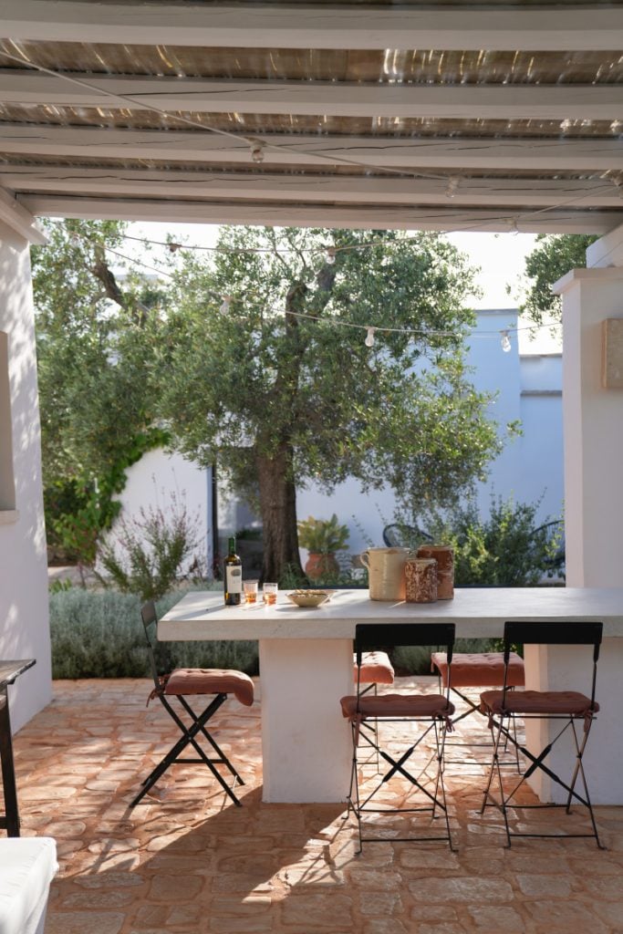 The exterior of a large, fortified traditional Puglian farmhouse or Masseria.