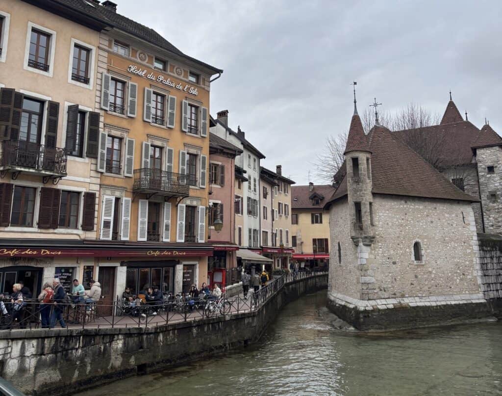 The triangular stone Palais de l'Isle building situated in the middle of a canal in Annecy's old town.