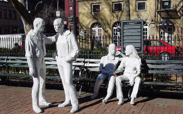White life-sized statues of people in Christopher Park at the Stonewall National Monument.