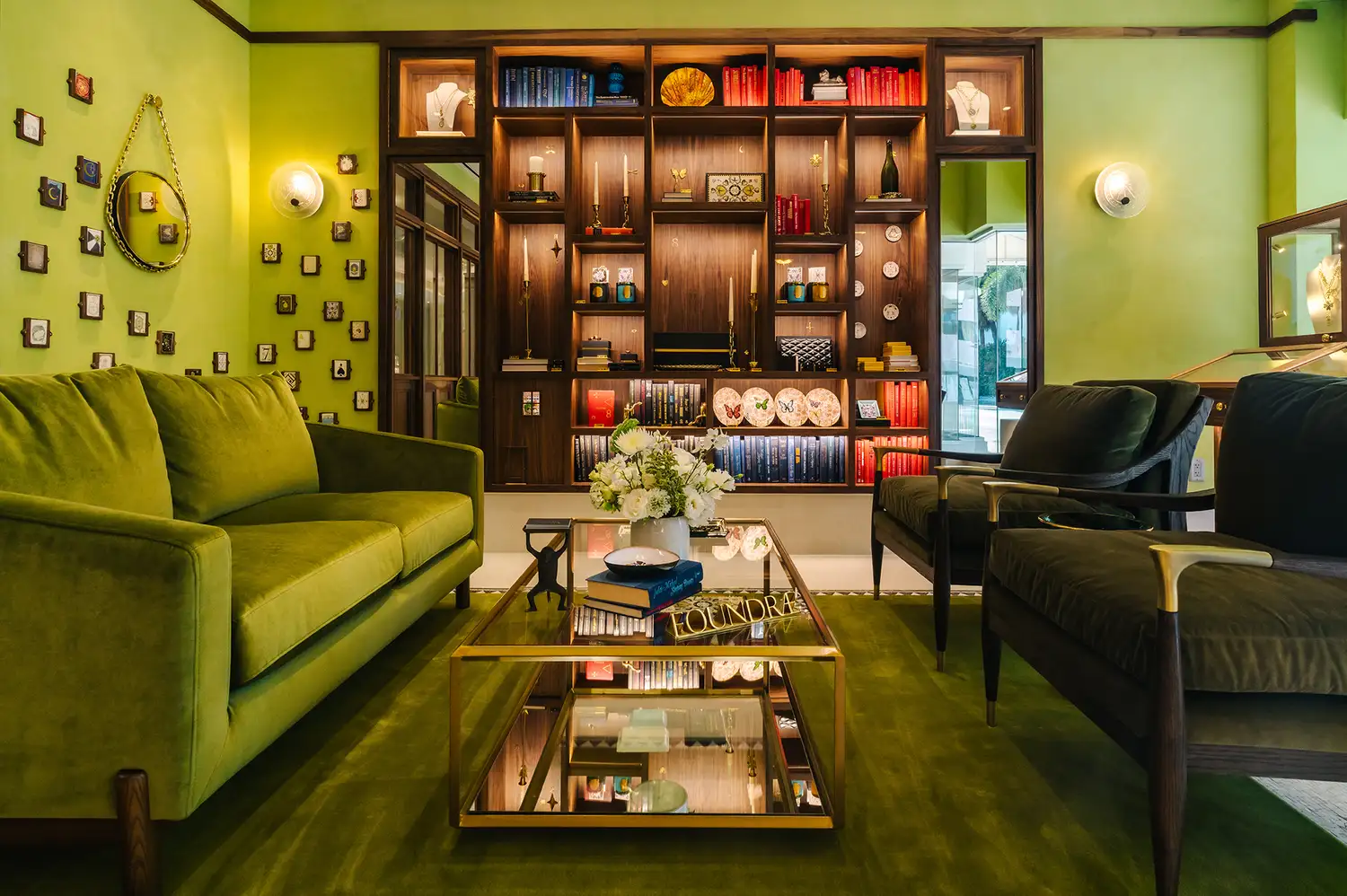 Modern interior of a luxury jewelry boutique with a green color theme and custom shelving.