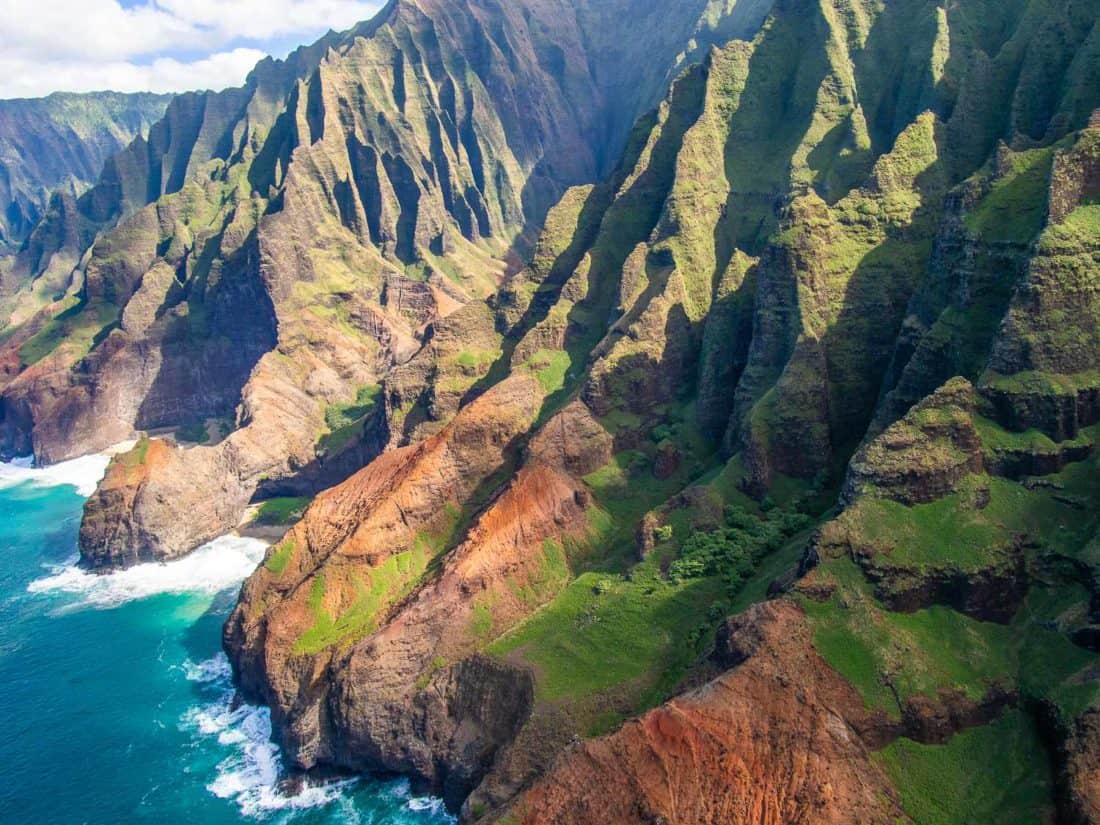 The sharp green ridges and valleys of the Na Pali Coast seen from the sea.