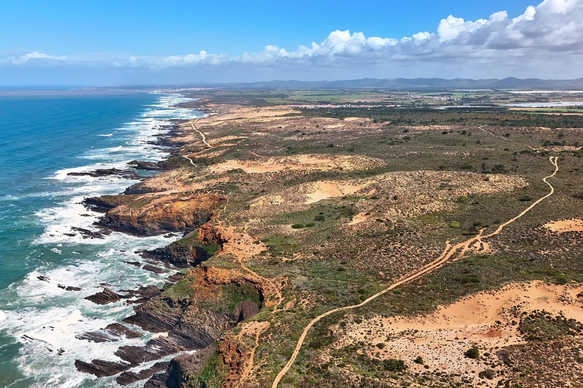 Rugged cliffs and blue ocean views along the Fisherman's Trail in Portugal.