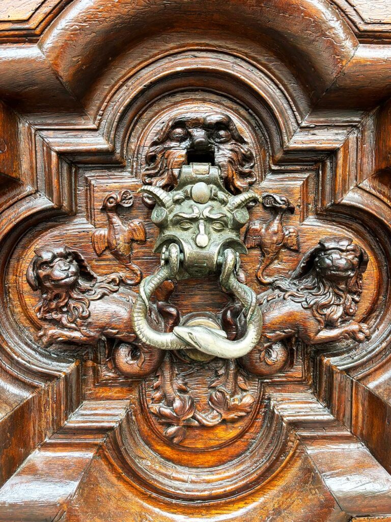 A detailed Baroque-style ornate doorway in Turin, Italy.