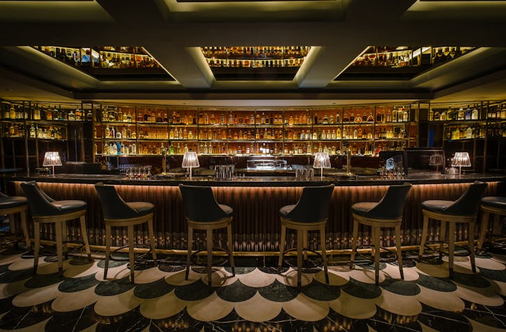 Opulent lounge seating and velvet curtains inside Manhattan bar