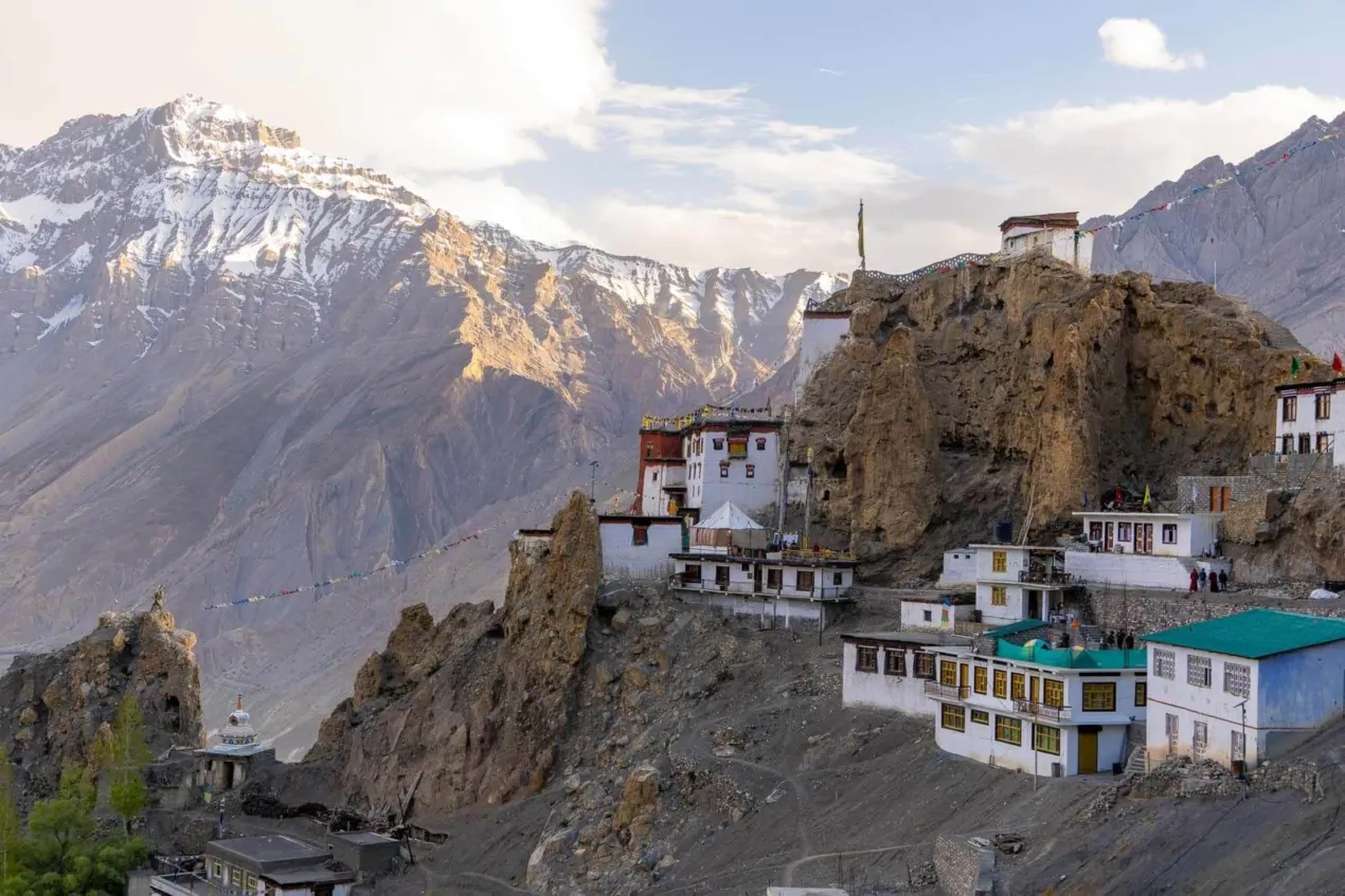 A white Buddhist monastery nestled in the high-altitude desert mountains of Spiti Valley.