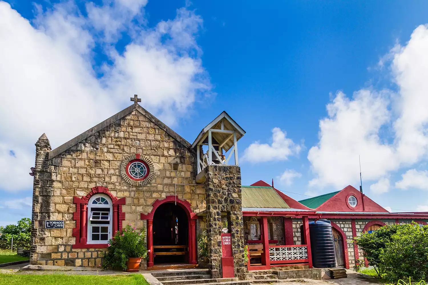A small stone Catholic church on a hilltop overlooking the village of Old Wall