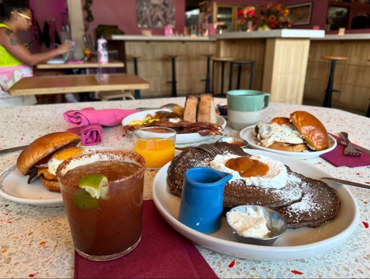 A platter of bar food including popcorn chicken and dipping sauces.