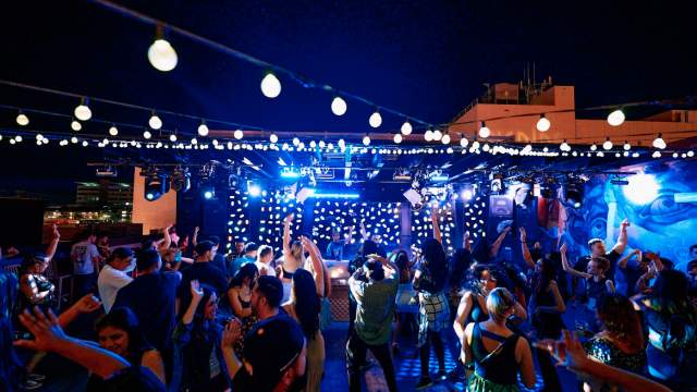 The vibrant and eclectic interior of a Downtown Las Vegas nightclub with neon signs.