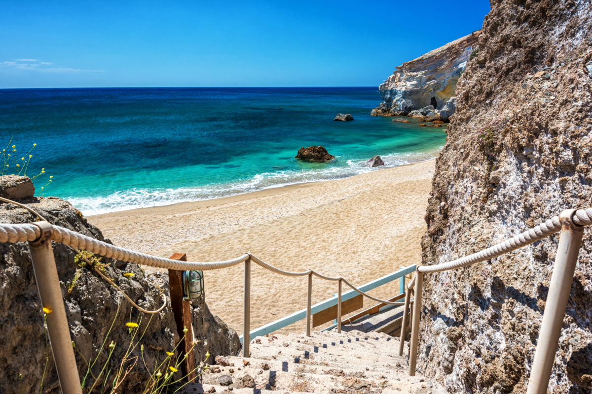 Close-up of multicolored volcanic pebbles and steep cliffs at Paleochori Beach in Milos.