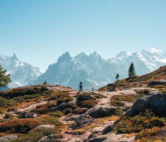 Hikers walking along a high-altitude trail in the Mont Blanc mountain range.