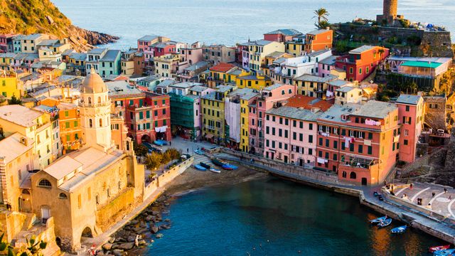 Brightly colored buildings along the coastline of Vernazza in Cinque Terre.