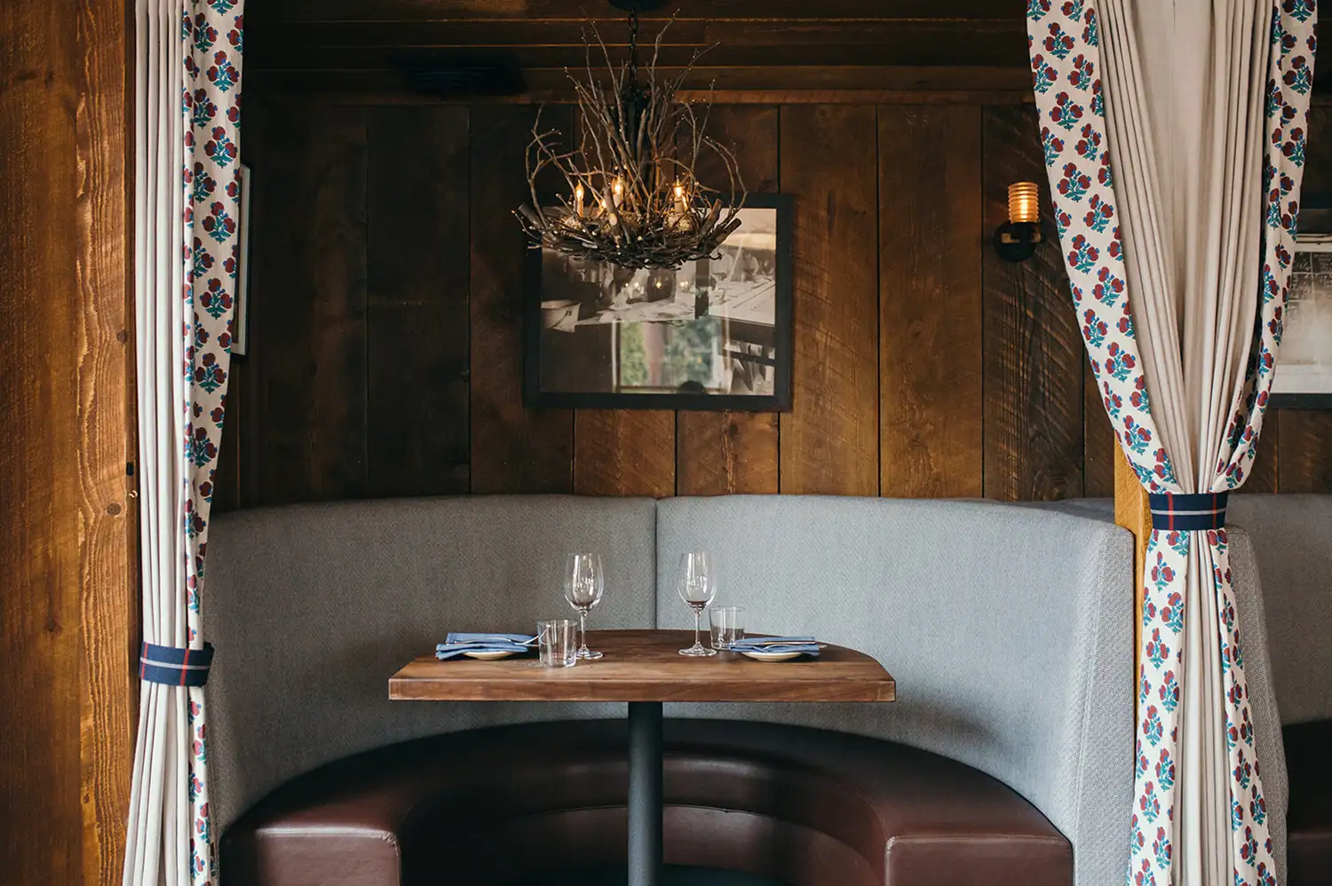 An intimate leather booth in a dimly lit, sophisticated restaurant setting.