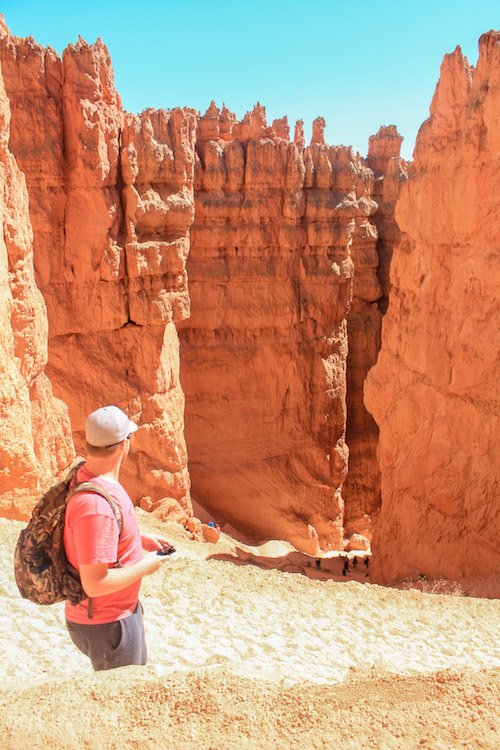 Deep orange canyon walls with steep zigzagging switchbacks leading to the canyon floor.