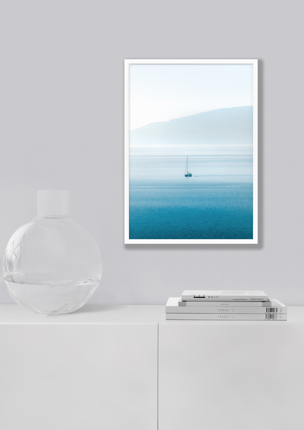 A sailboat gliding through the blue waters of the Puget Sound with green islands in the distance.