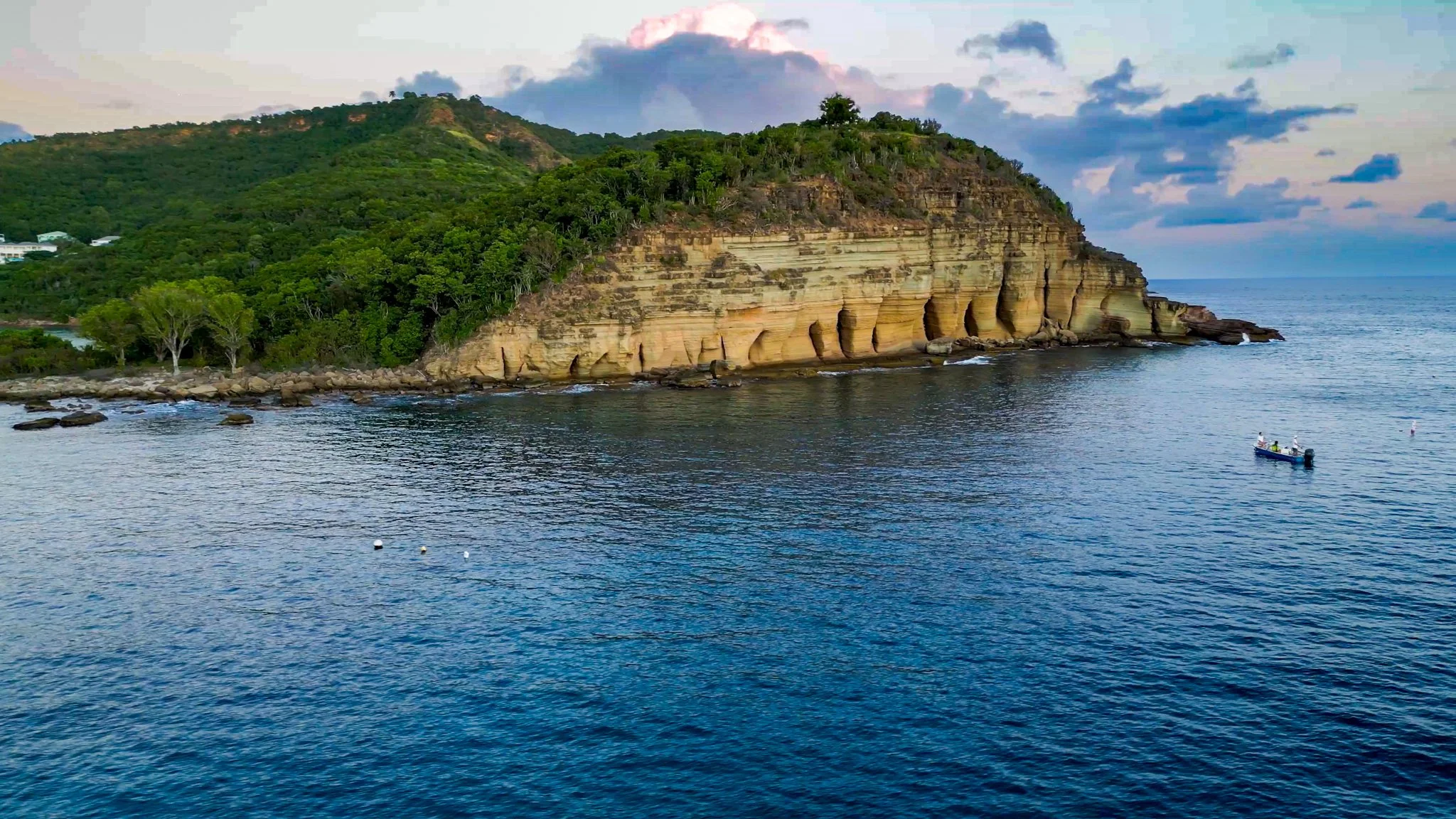Vertical limestone cliff formations known as the Pillars of Hercules overlooking the sea in Antigua.