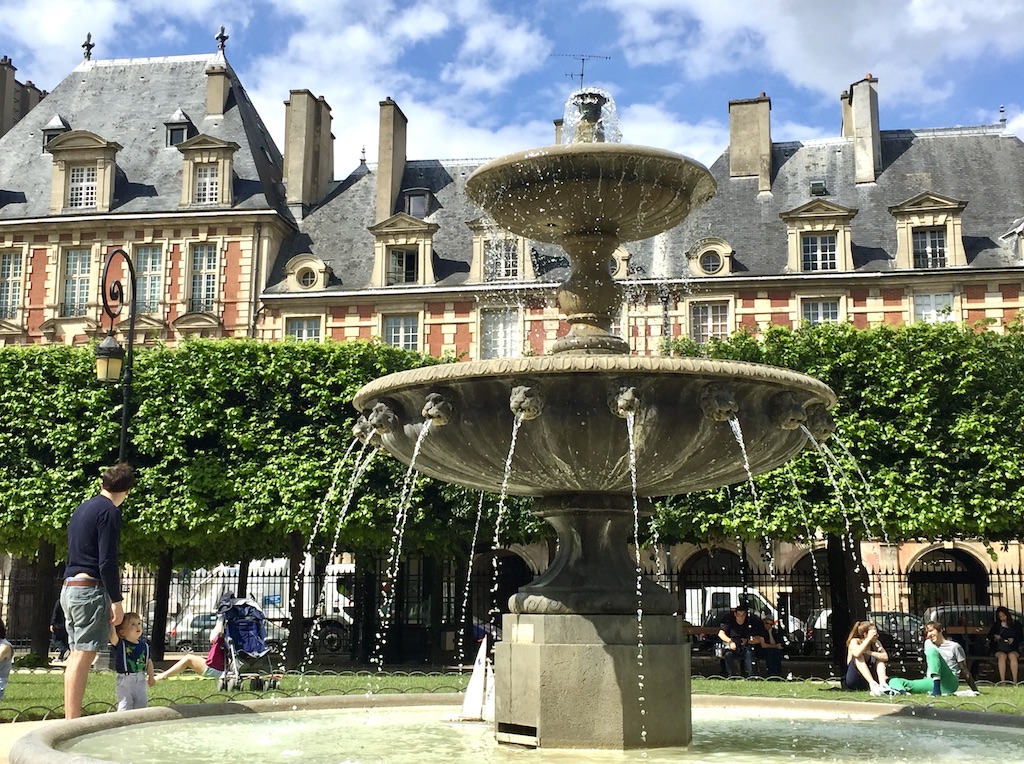 The historic and symmetrical architecture of Place des Vosges in the Marais.