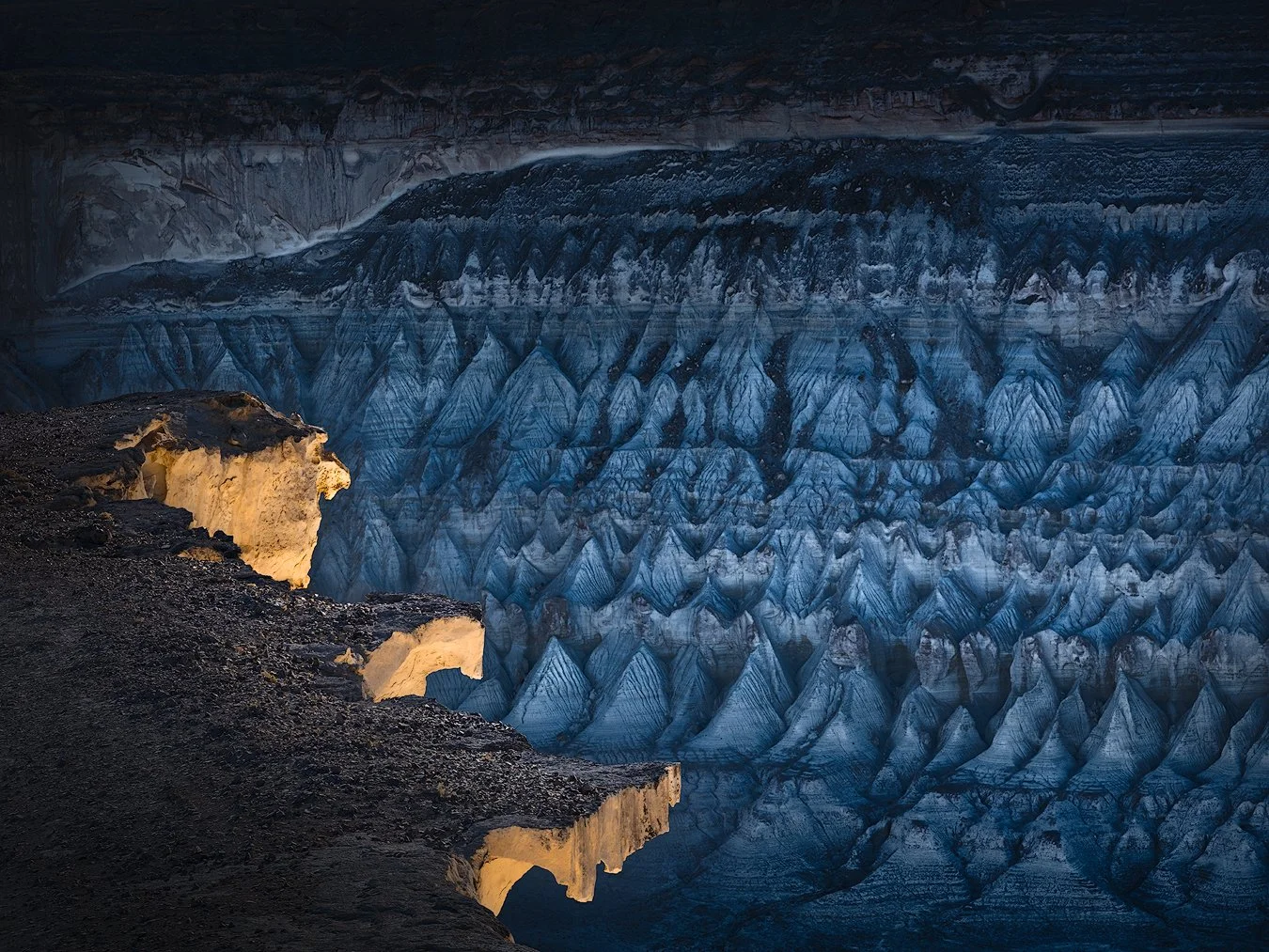 High contrast sunlight and deep shadows playing across the rugged desert rock formations.