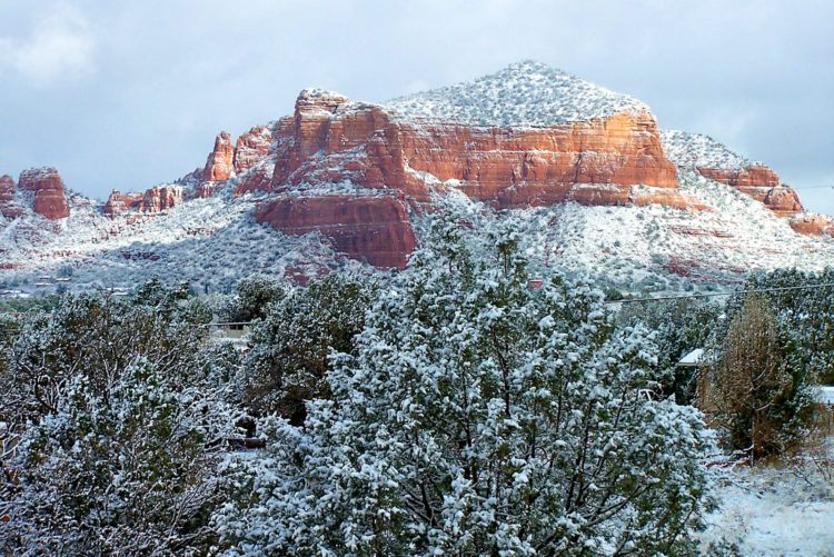 The iconic red rock sandstone formations of Sedona, Arizona under a blue sky.
