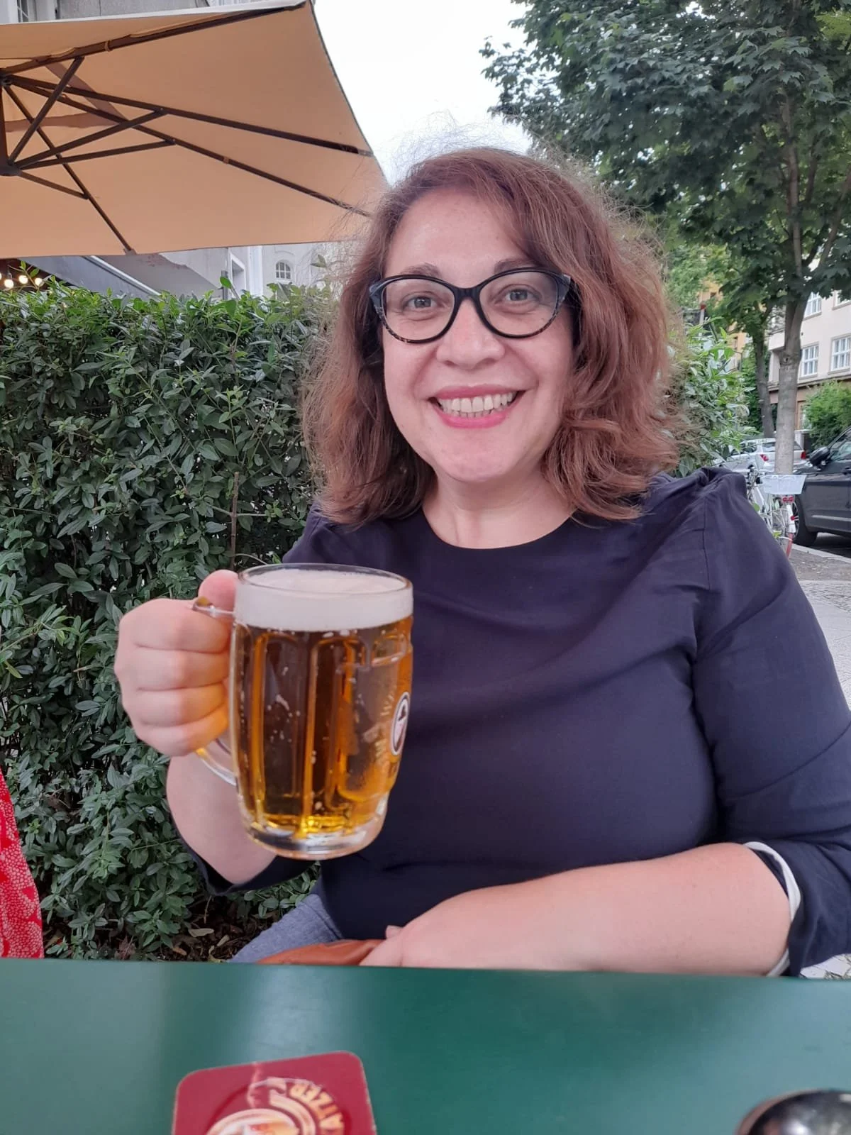 A cold glass of German beer on an outdoor table.