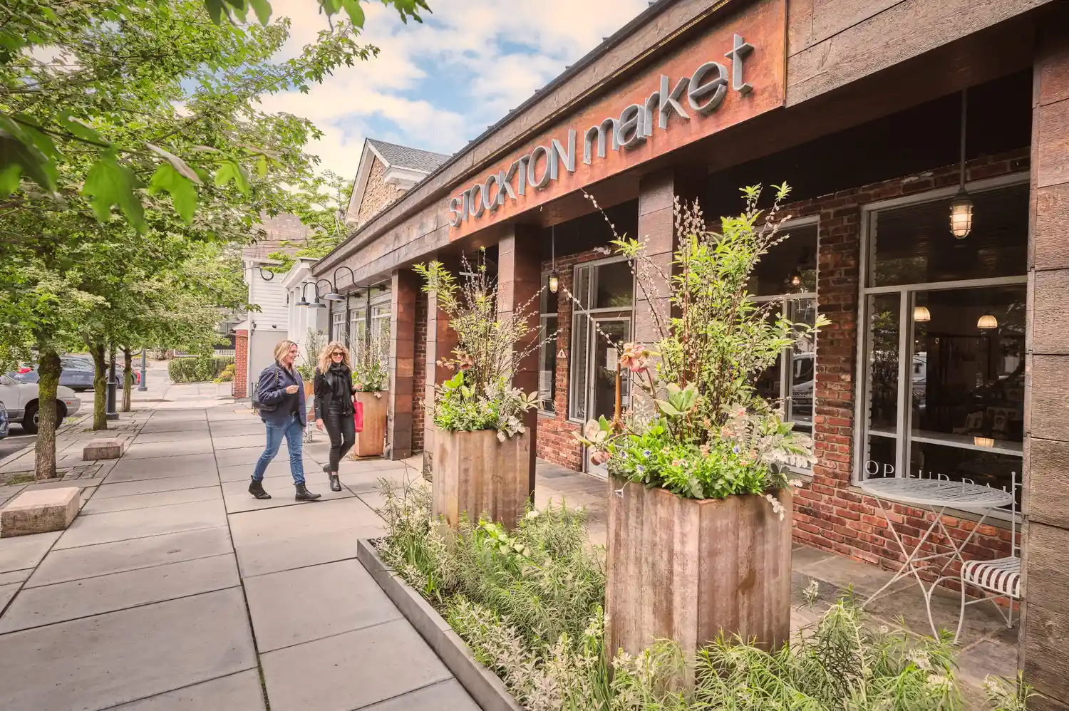 People walking into the Stockton Market, a rustic-style artisan market.