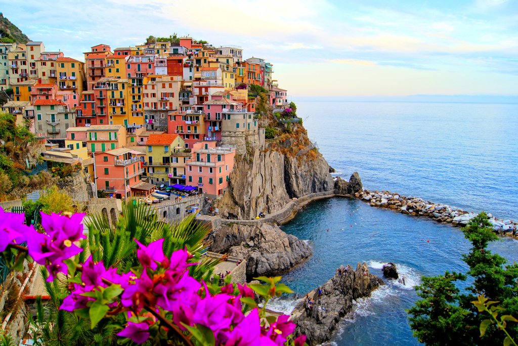Brightly colored houses stacked on a cliffside overlooking the sea in the Cinque Terre region.