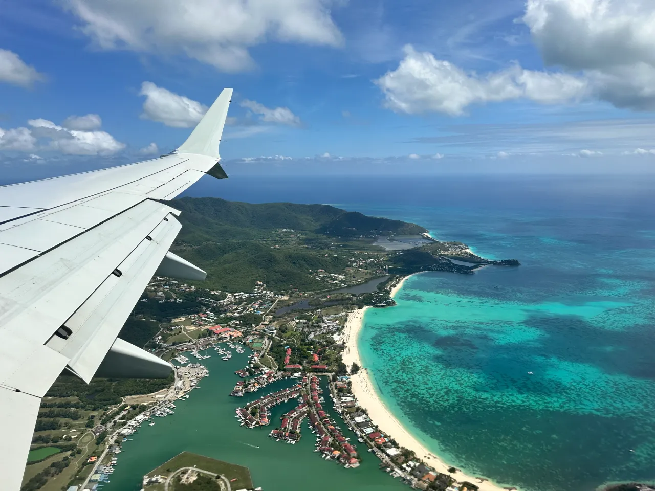 Aerial view of Caribbean islands surrounded by vibrant blue coral reefs.