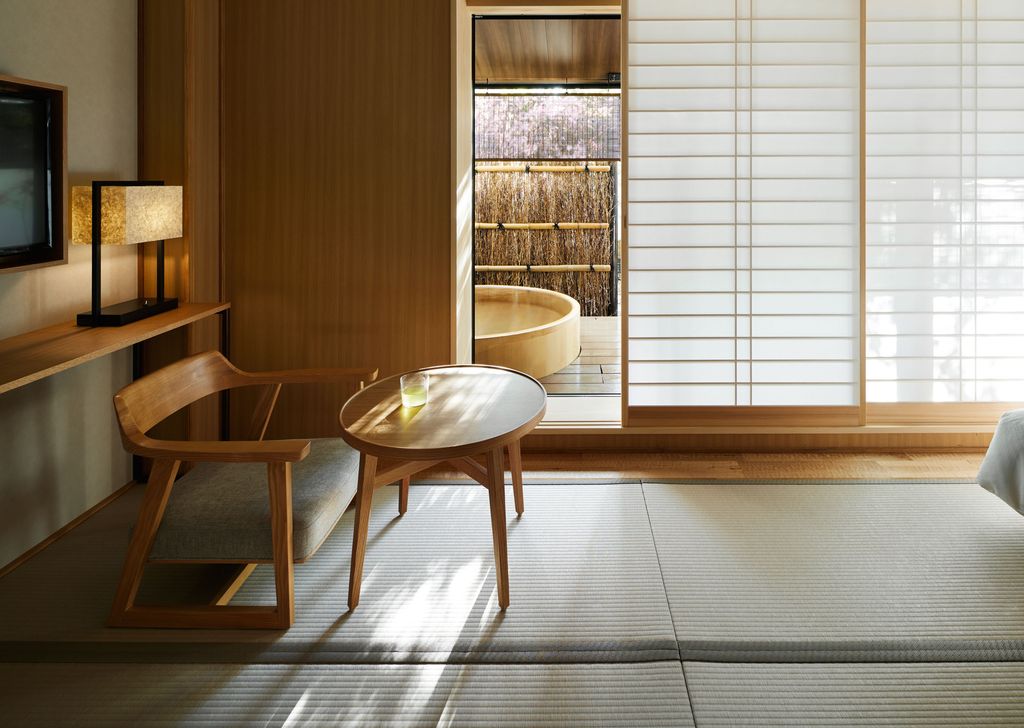 Traditional Japanese ryokan room with tatami mats and a sliding door at Yuen Bettei Daita.