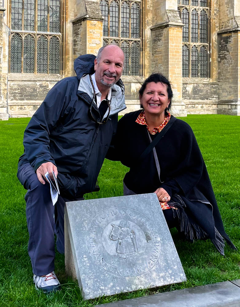 The Gothic stone towers and intricate facade of Canterbury Cathedral against a clear sky.